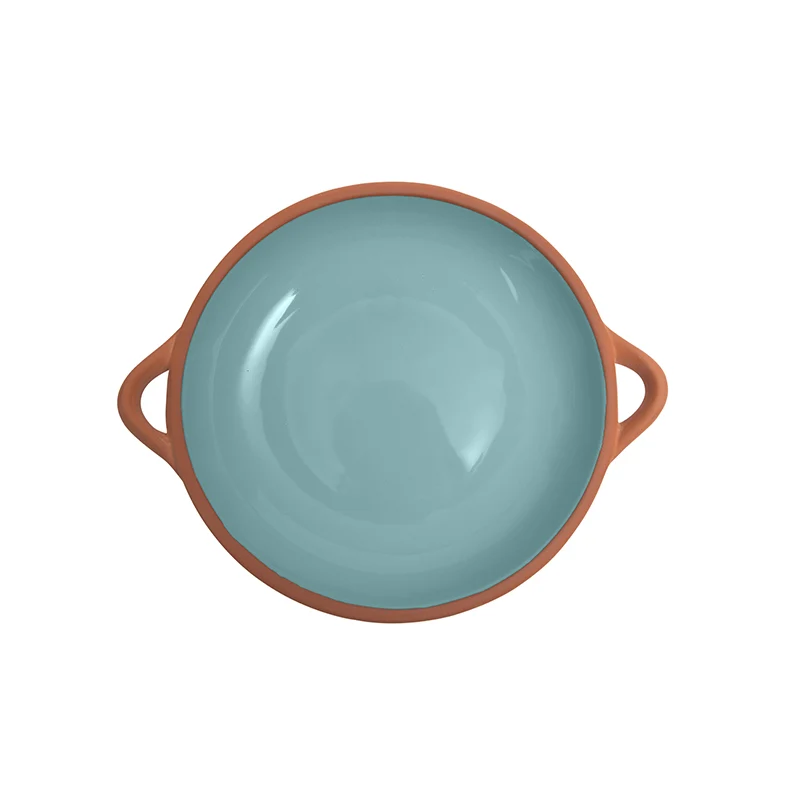  A round shallow dish made from terracotta with a light blue glaze 