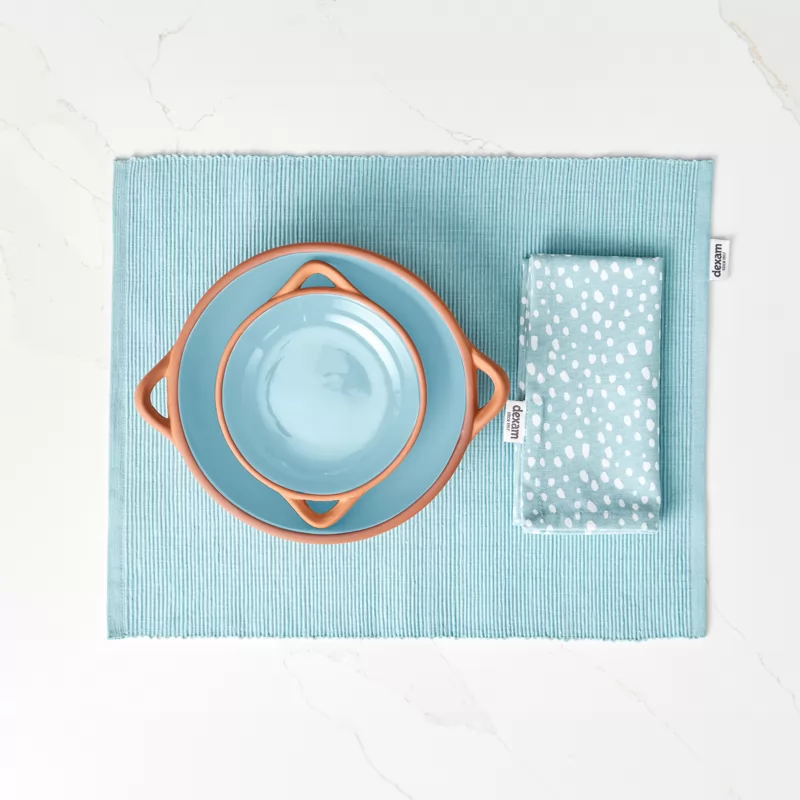 a set of two different sized terracotta dishes with a light blue glaze