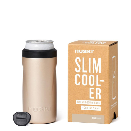 HUSKI slim cooler with beige tumbler and packaging on a white background