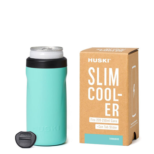 Teal slim cooler with black lid and Huski branding next to its packaging on a white background