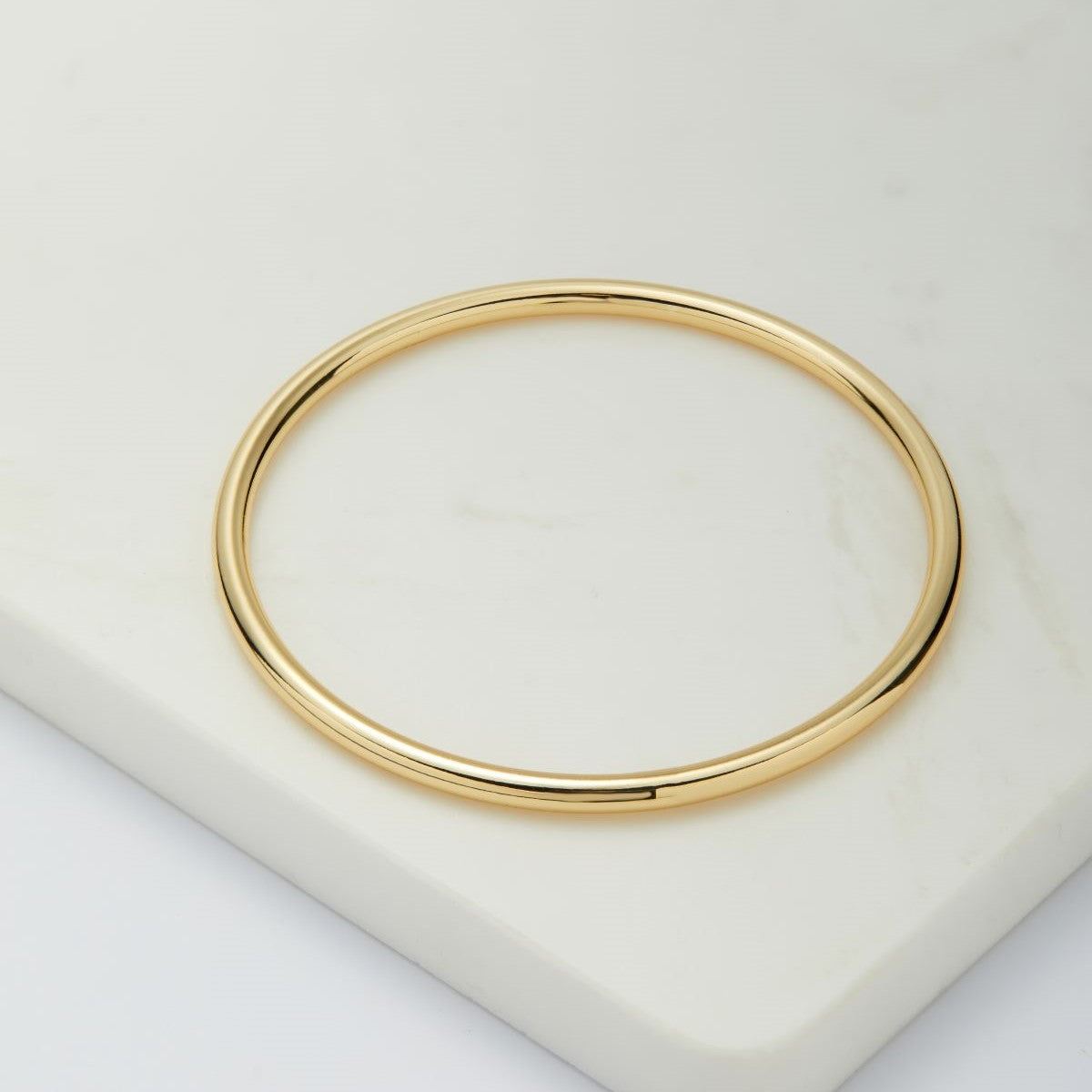 a gold plated bracelet with solid gold texture 