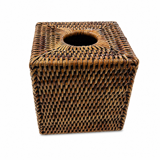 A square woven rattan or wicker tissue box cover with a circular opening at the top,