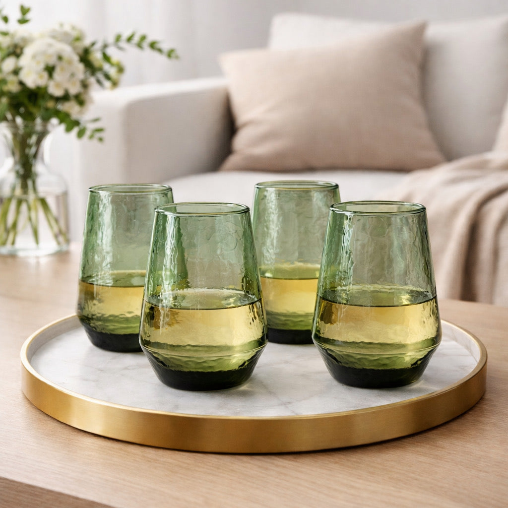 Four green glass tumblers 