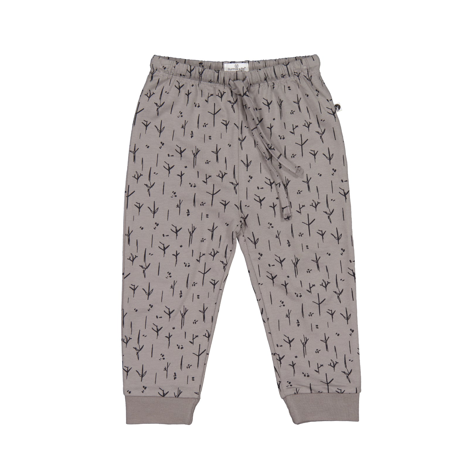 A pair of gray track pants with a stick and stone print, featuring pockets and a drawstring waist.