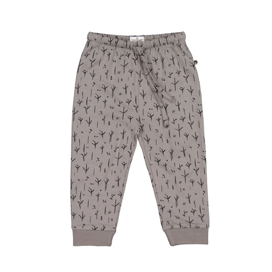 A pair of gray track pants with a stick and stone print, featuring pockets and a drawstring waist.
