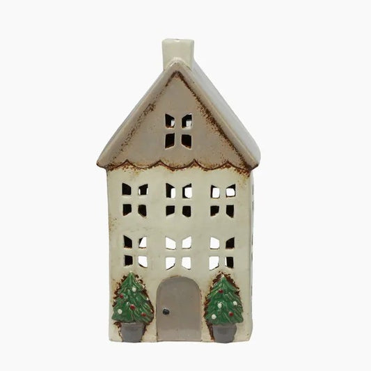 Ceramic house-shaped lantern with cut-out windows and two small trees