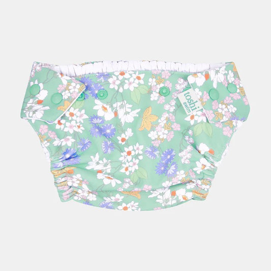 A floral-patterned Toshi baby swim diaper with adjustable press studs and elastic leg bands.