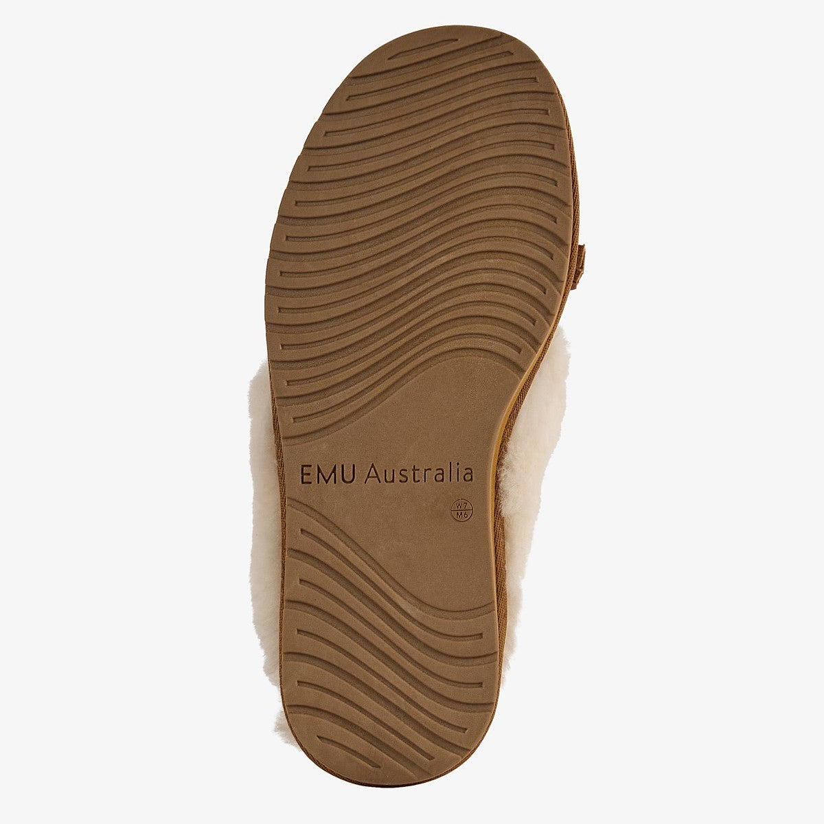 The brown rubber outsole of a slip-on shoe with white shearling lining, showing the 'EMU Australia' branding, on a light gray background.