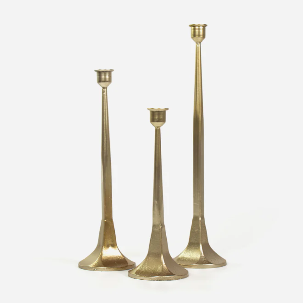 Three gold candle holders of different heights