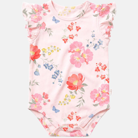 A baby bodysuit in light pink with a watercolor floral print featuring red, pink, blue, and yellow flowers, green leaves, and small blue butterflies. It has ruffled cap sleeves and a snap closure at the bottom.