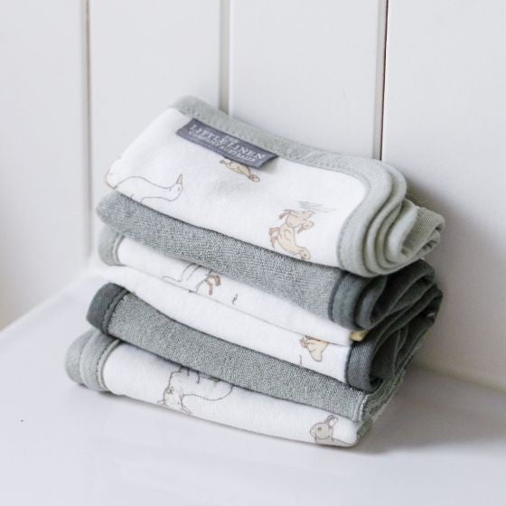 Set of 6 sage green wash cloths for babies with farm animals on bathroom surface background