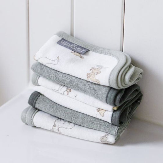 Set of 6 sage green wash cloths for babies with farm animals on bathroom surface background