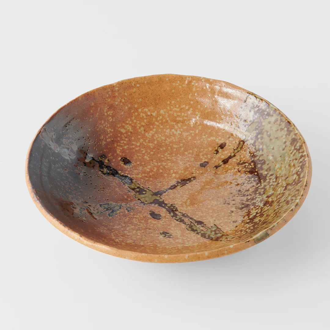 A handmade ceramic bowl with a rustic, hand-painted glaze featuring a mottled blend of brown, tan, and dark charcoal accents.