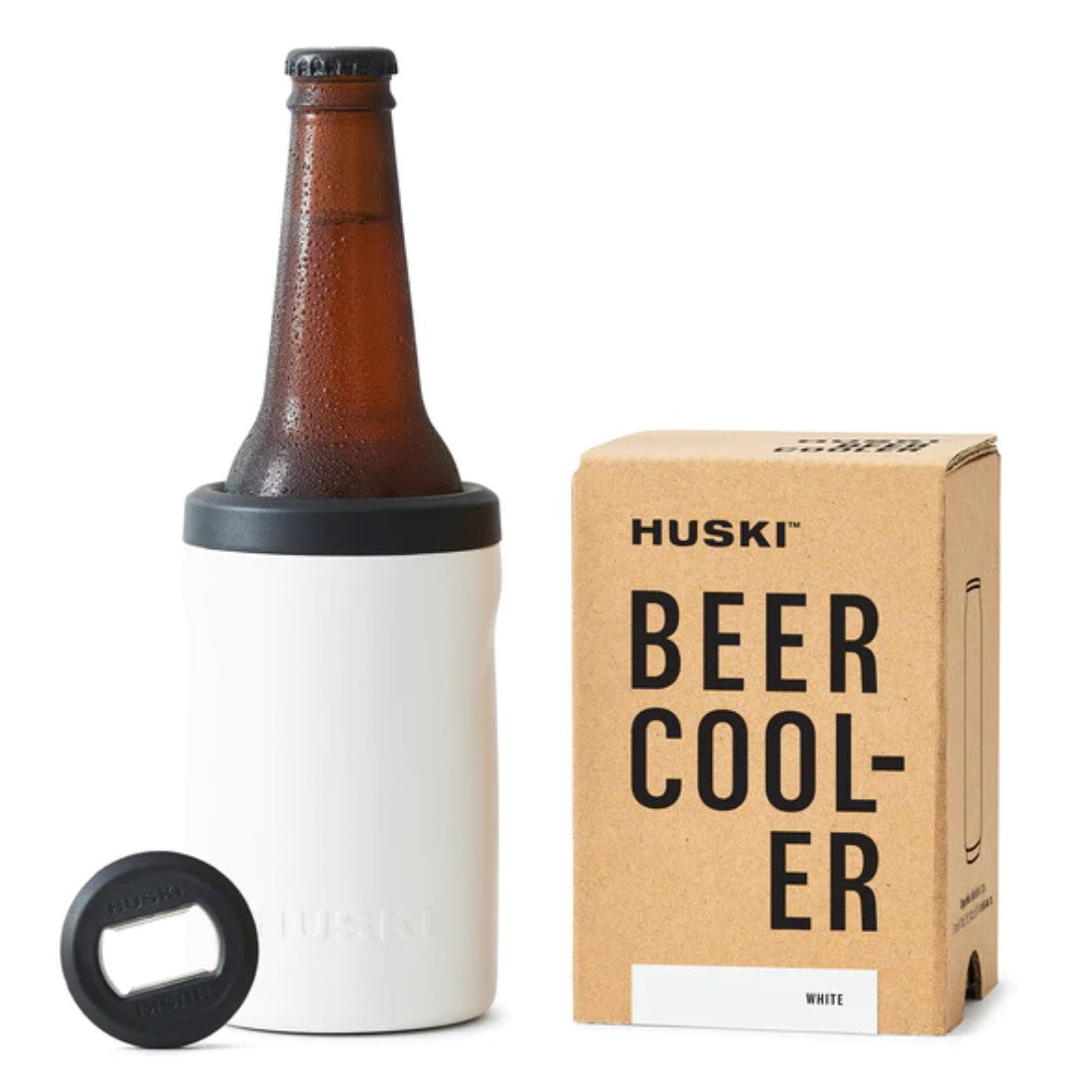 A white Huski Beer Cooler 2.0 with a bottle of beer inside, next to its packaging box with the product branding visible.