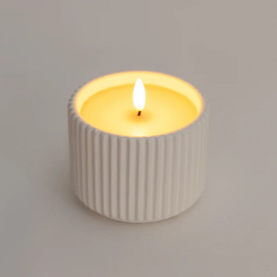 Candle in a ribbed ceramic holder