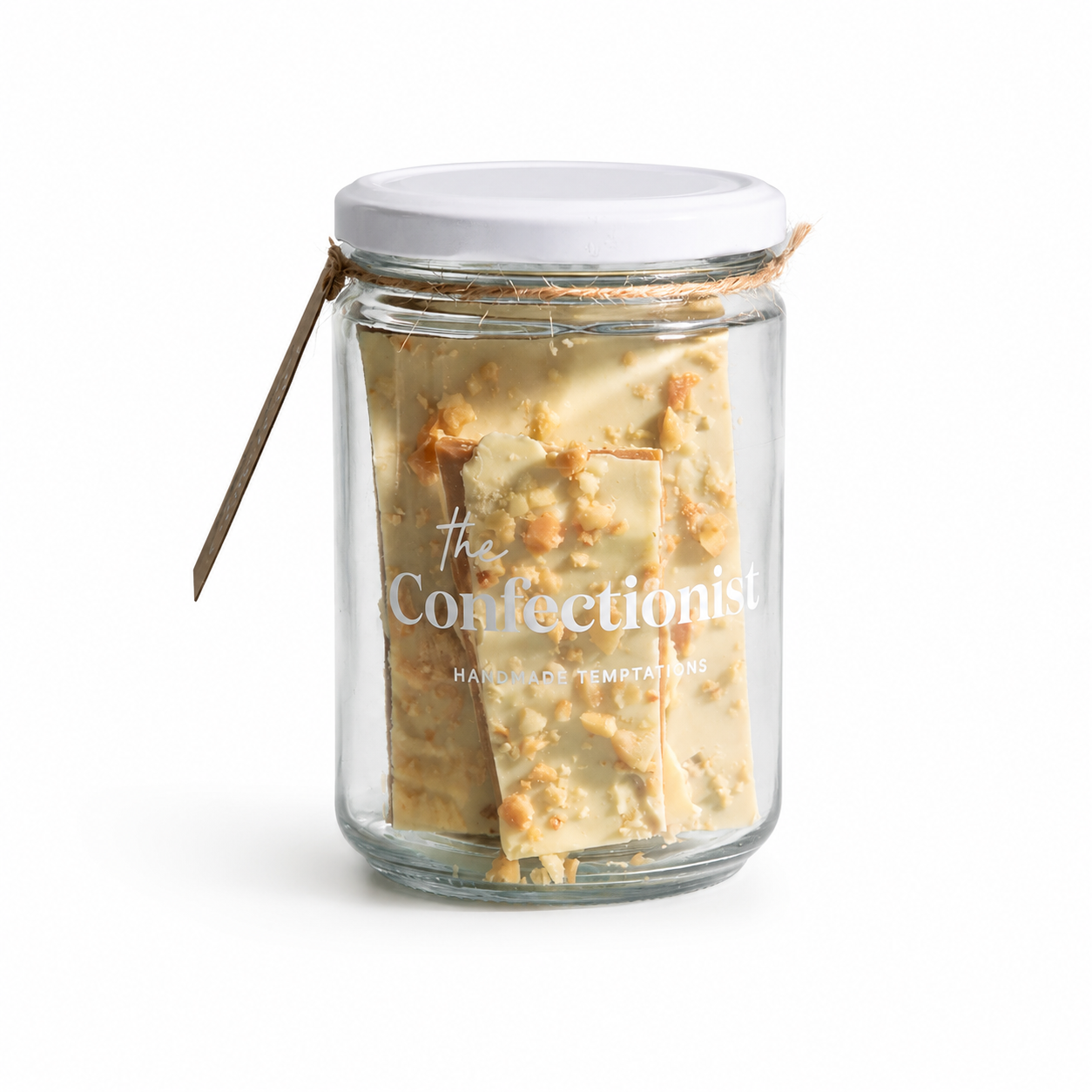 A clear glass jar filled with cream-colored chocolate bark pieces, sealed with a white lid and tied with a thin string.