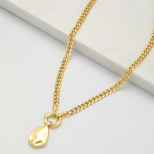 A gold-colored necklace with a single gold-colored pendant on a chain