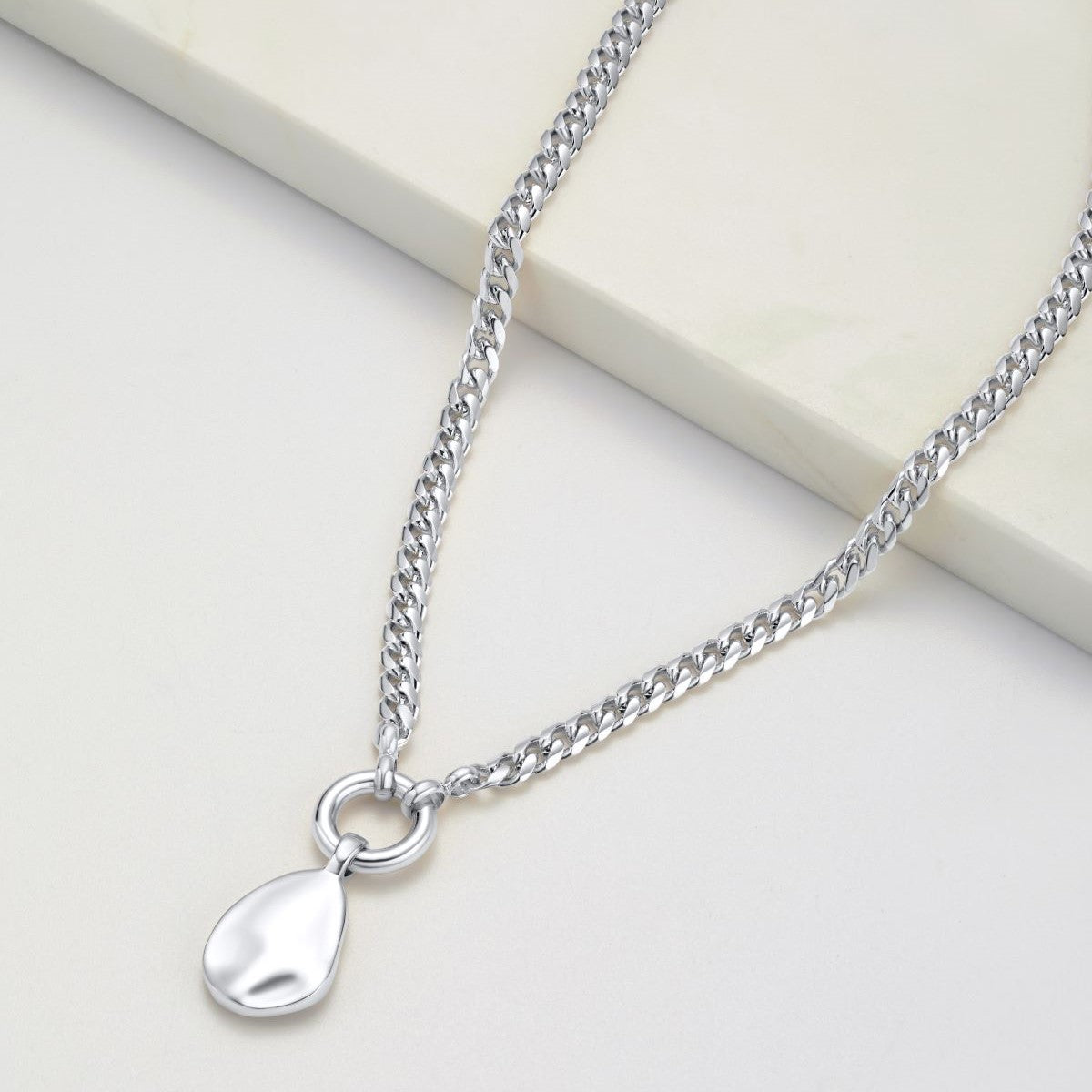 A silver chain with silver pendent on the end 