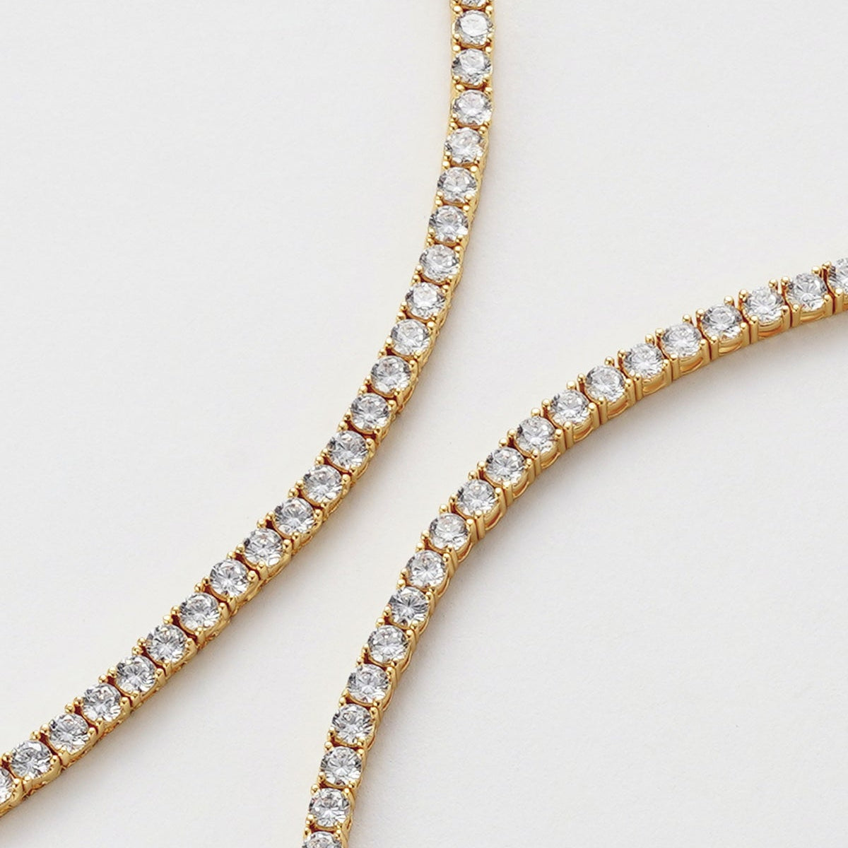 Gold necklace with small stones place closely together 
