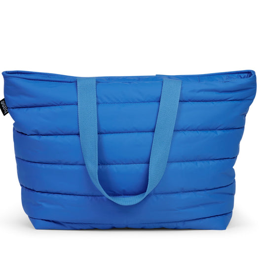 A blue padded shoulder bag with two straps and a chunky zip closure.