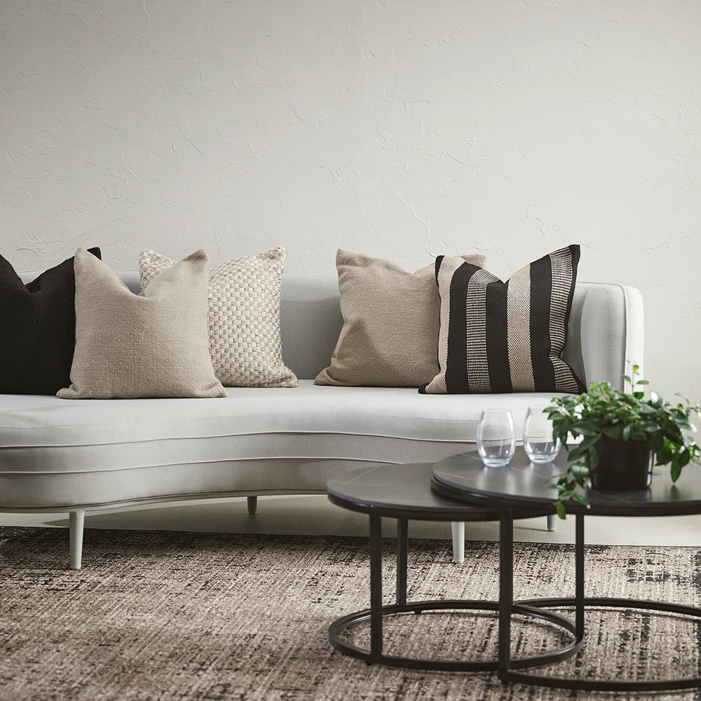 an arrayed of cushions with black and natural colourway 