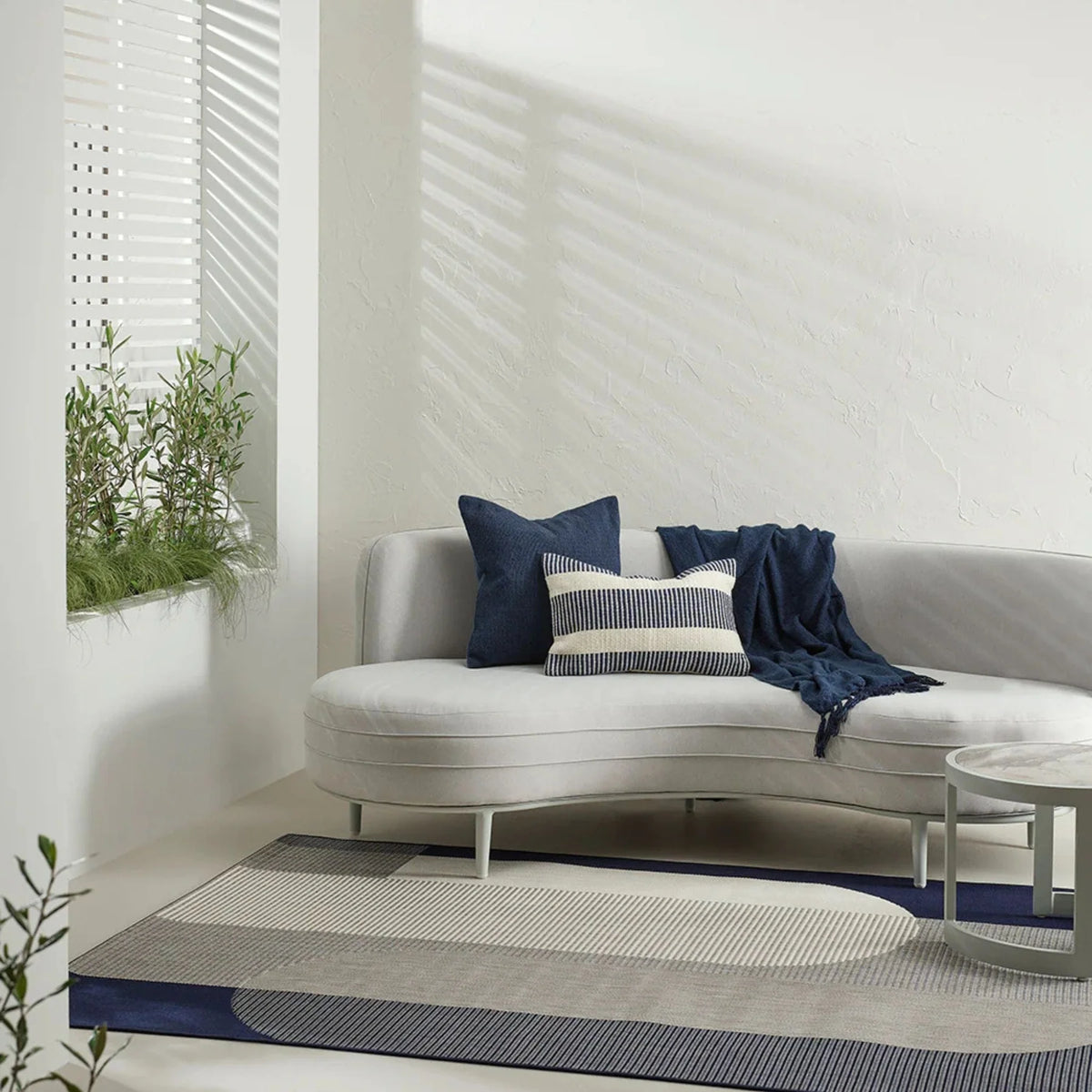 Navy cushion on a soft coloured sofa 
